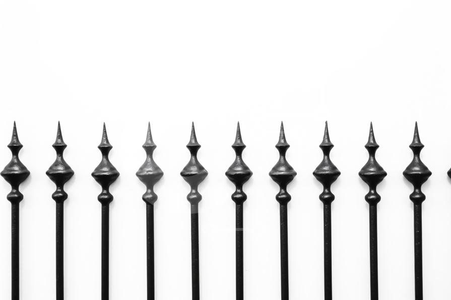 Black Metal Fence Posts with Spikes Stock Photo stock photo Creative Fabrica