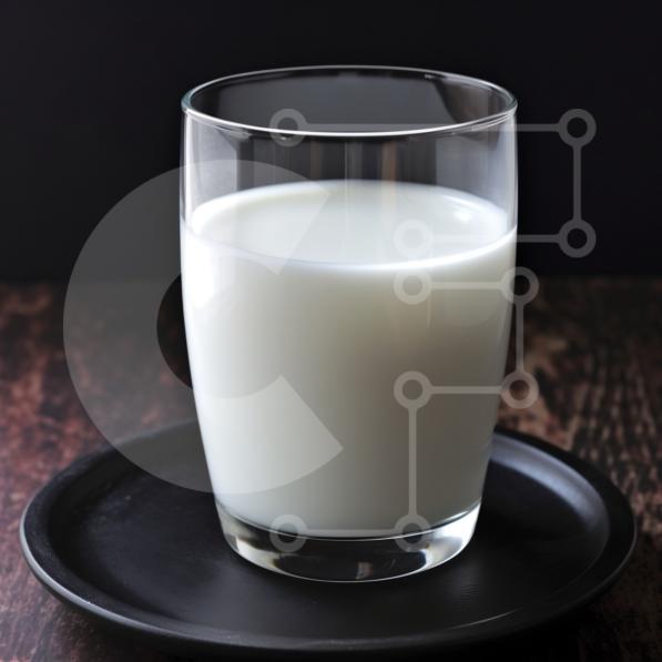 Glass of Milk on Black Plate stock photo Creative Fabrica