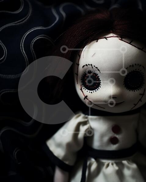 Vintage Doll with Red Eyes on Dark Blue Fabric stock photo | Creative