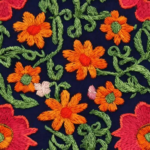 Embroidered Fabric with Orange and Green Flowers on Dark Blue Background Embroidered Fabric with Orange and Green Flowers on Dark Blue Background thumbnail