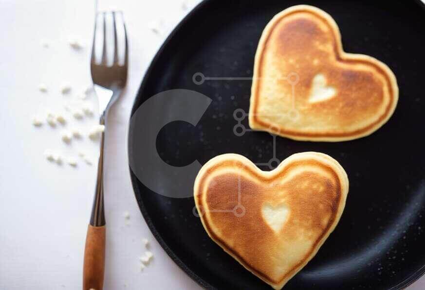 Heart-shaped Pancakes with Fork and Knife stock photo | Creative Fabrica