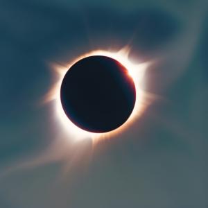 Imagem impressionante de um eclipse solar com sol parcial e céu azul profundo thumbnail